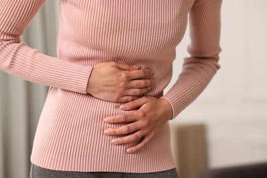 Photo of Indigestion problem. Woman suffering from stomachache, closeup