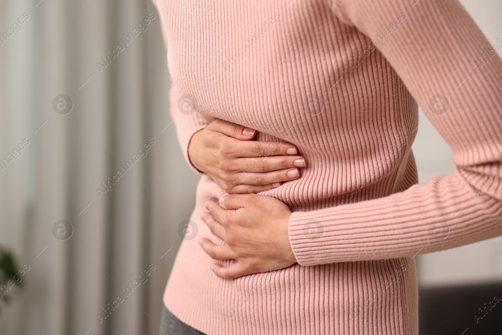 Photo of Indigestion problem. Woman suffering from stomachache, closeup