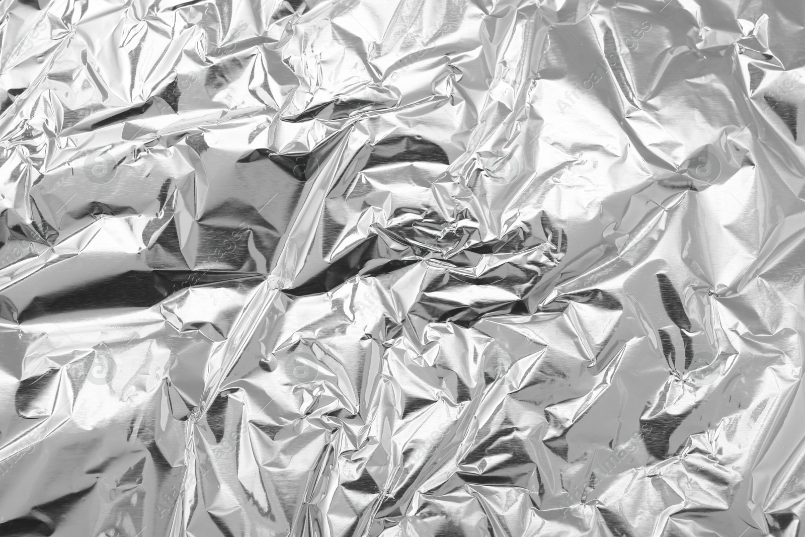 Photo of Crumpled silver foil as background, top view