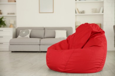 Red bean bag chair on floor in room