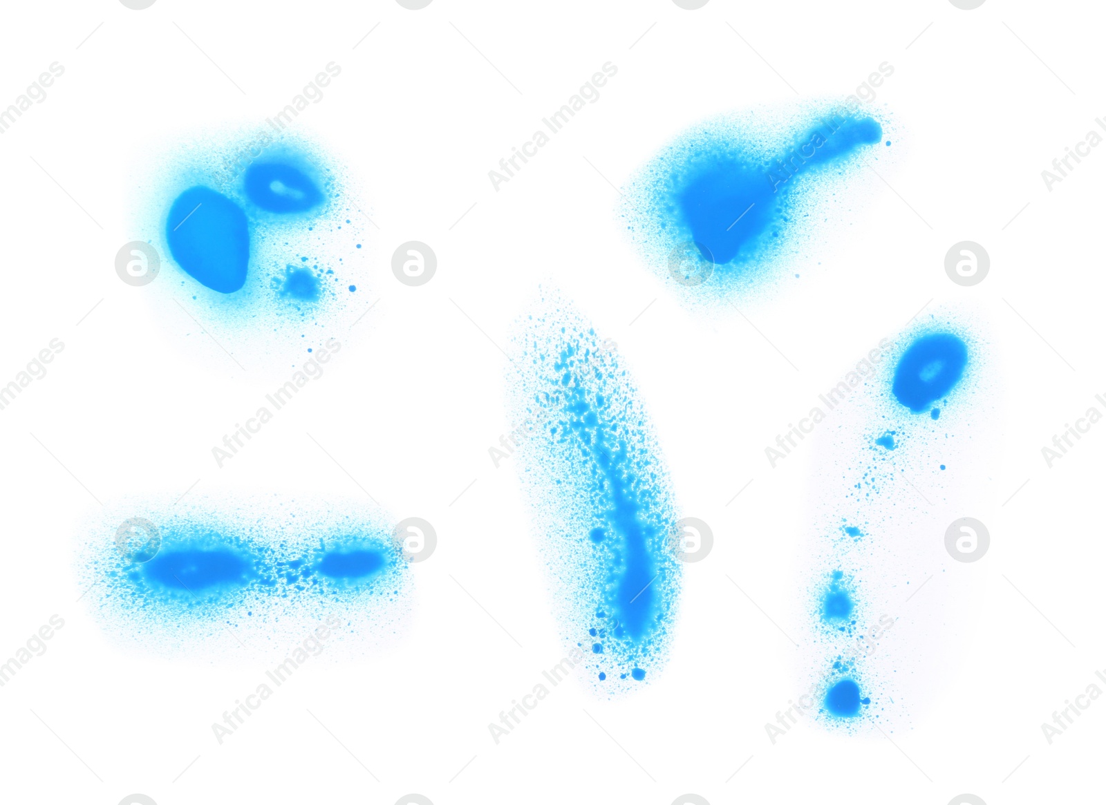 Photo of Abstract spots drawn by blue spray paint isolated on white, top view