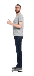 Photo of Man with good posture showing thumbs up on white background