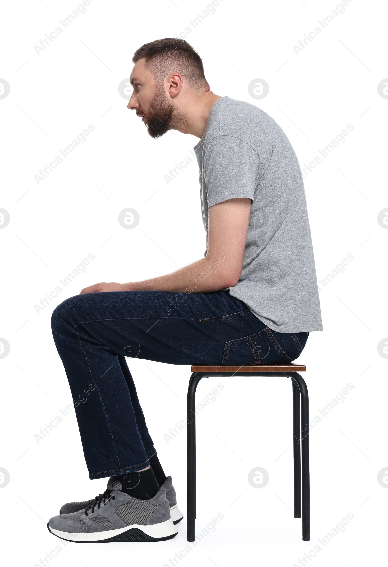 Photo of Man with poor posture sitting on chair against white background