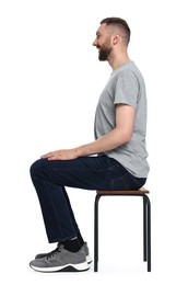 Man with good posture sitting on chair against white background