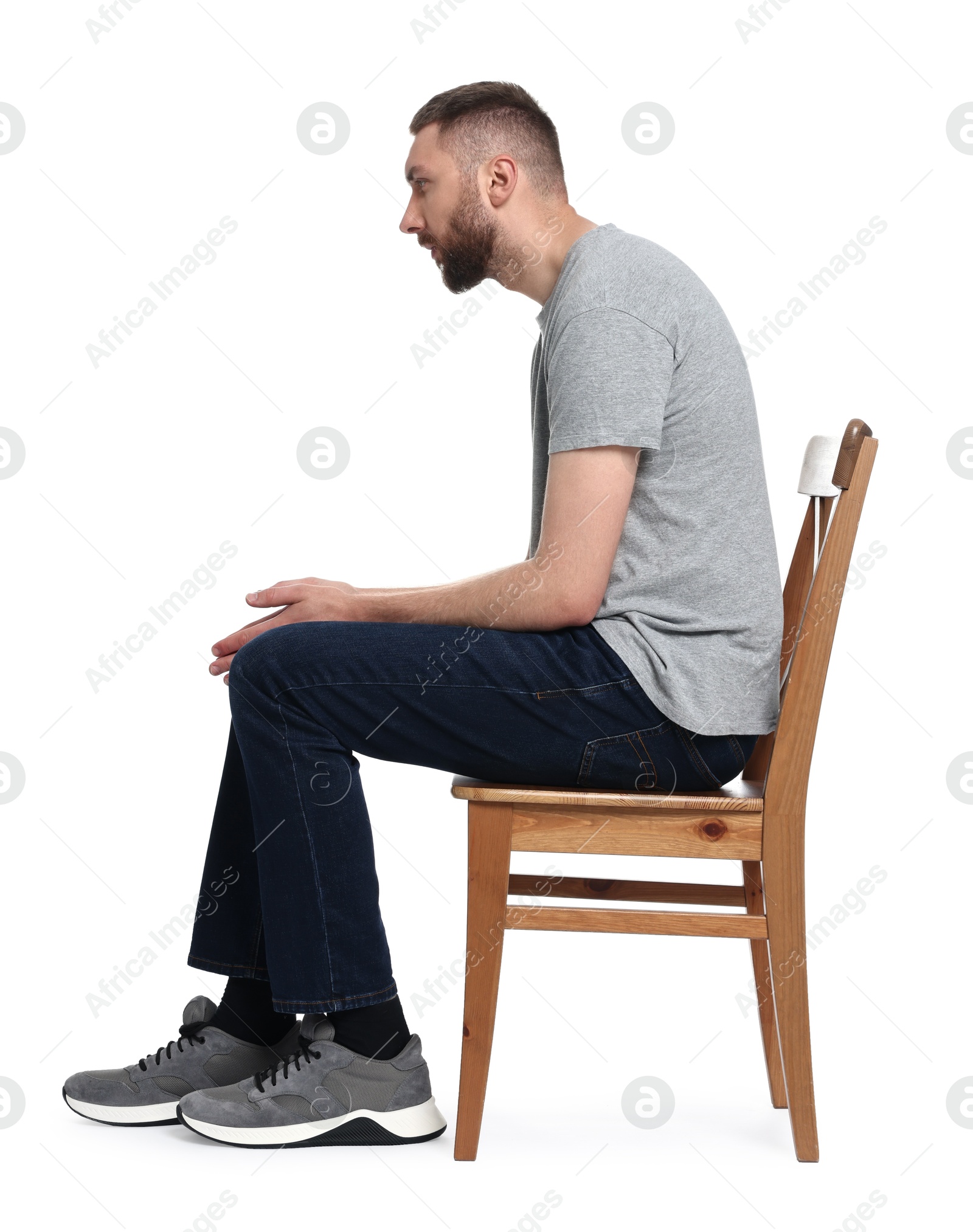 Photo of Man with poor posture sitting on chair against white background