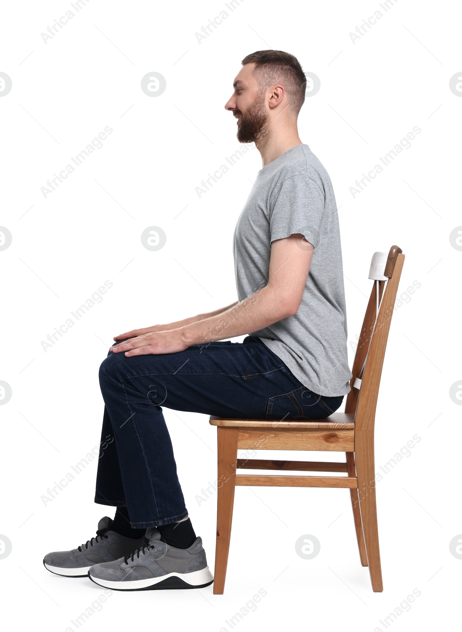 Photo of Man with good posture sitting on chair against white background