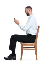 Man with good posture sitting on chair and using smartphone against white background