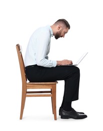 Photo of Man with poor posture sitting on chair and using laptop against white background