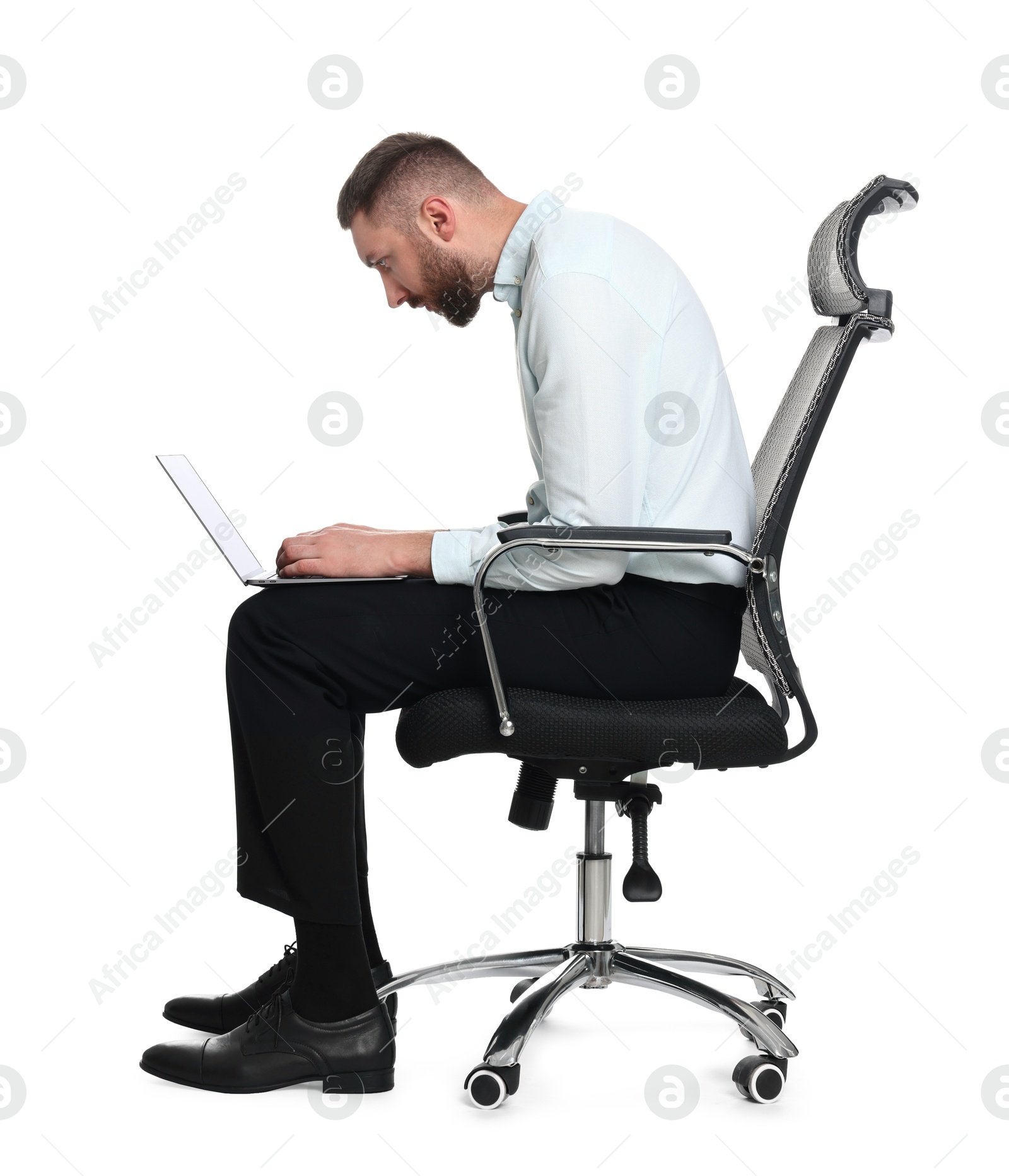 Photo of Man with poor posture sitting on chair and using laptop against white background