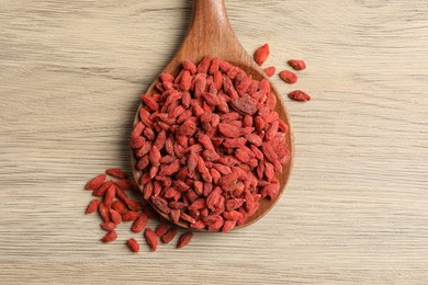 Dried goji berries on wooden table, top view