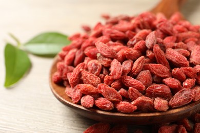 Dried goji berries on wooden table, closeup