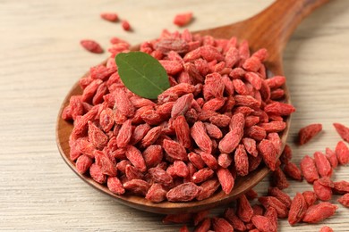 Dried goji berries on wooden table, closeup