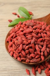 Dried goji berries on wooden table, closeup