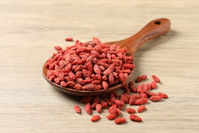 Photo of Dried goji berries on wooden table, closeup