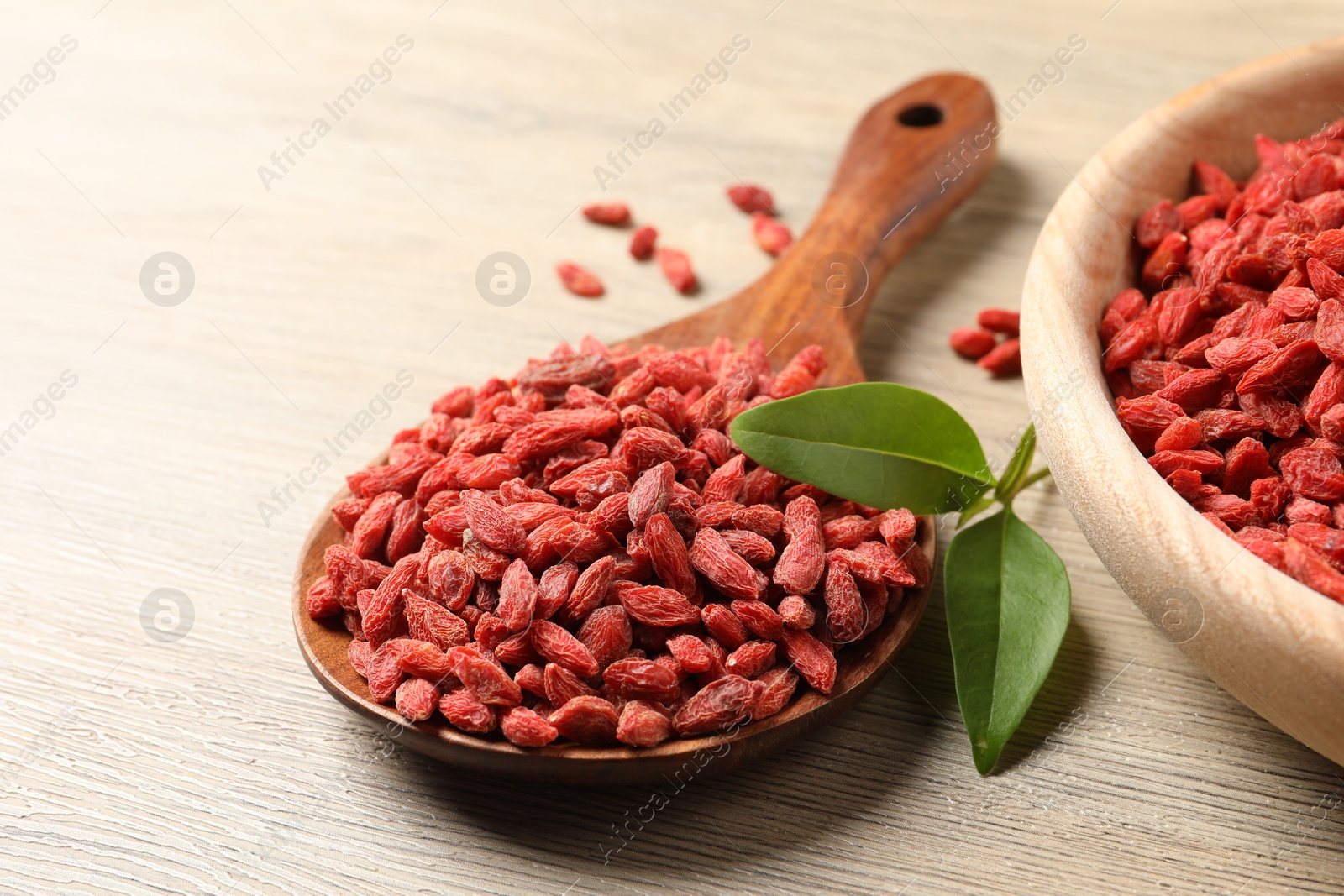 Photo of Dried goji berries on wooden table, closeup