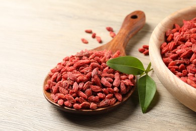 Dried goji berries on wooden table, closeup