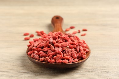 Dried goji berries on wooden table, closeup