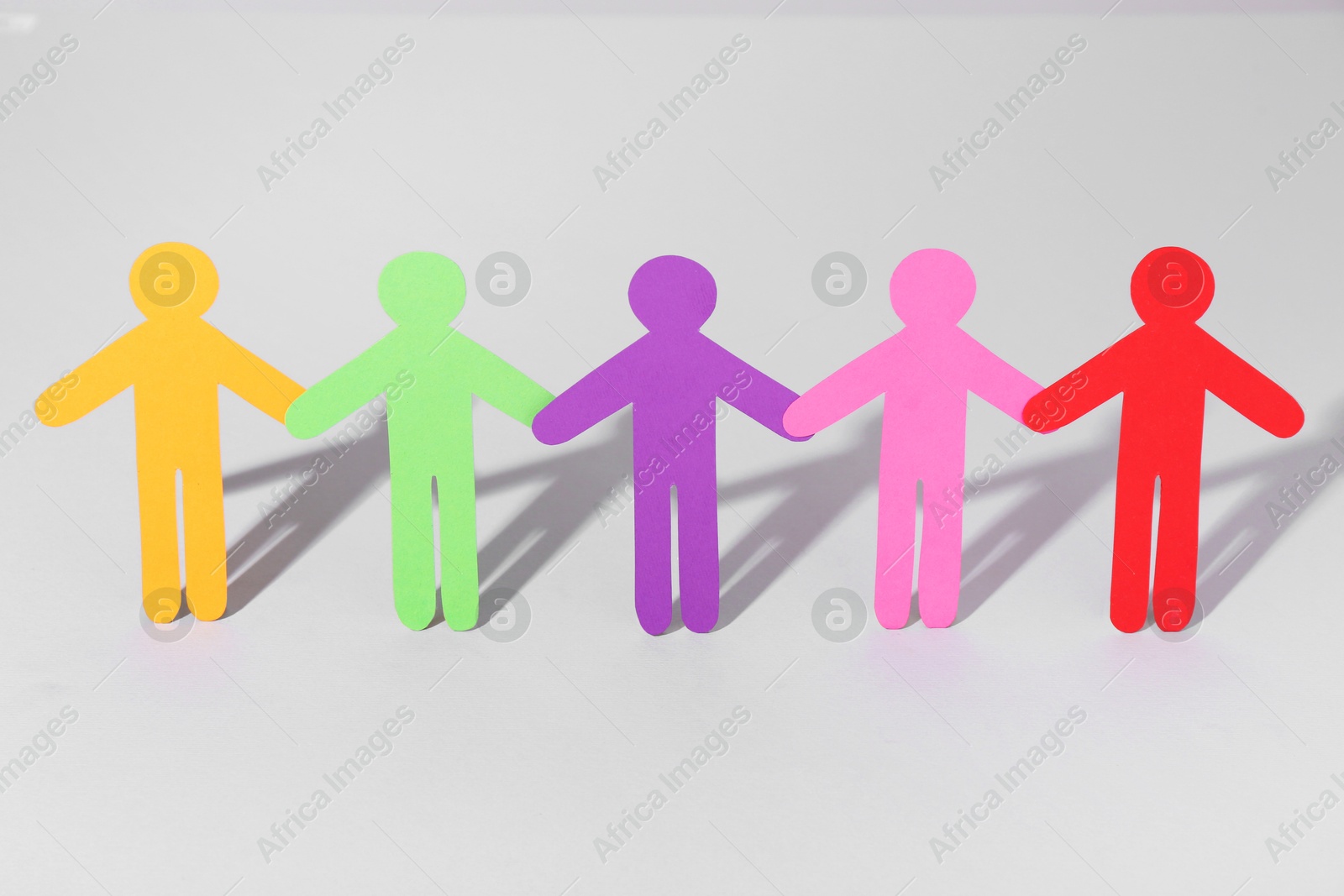 Photo of Equality concept. Paper human figures on light background