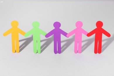 Photo of Equality concept. Paper human figures on light background