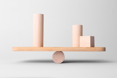 Equality concept. Seesaw scale with wooden blocks on light background