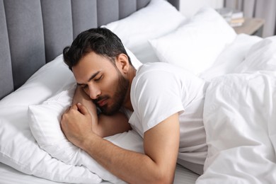 Photo of Handsome man sleeping in bed at morning