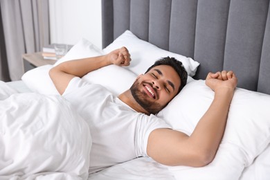 Handsome man sleeping in bed at morning