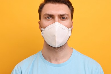 Photo of Man in respirator mask on yellow background
