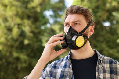 Photo of Man in respirator mask outdoors. Safety equipment