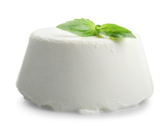 Photo of Fresh ricotta (cream cheese) and basil isolated on white