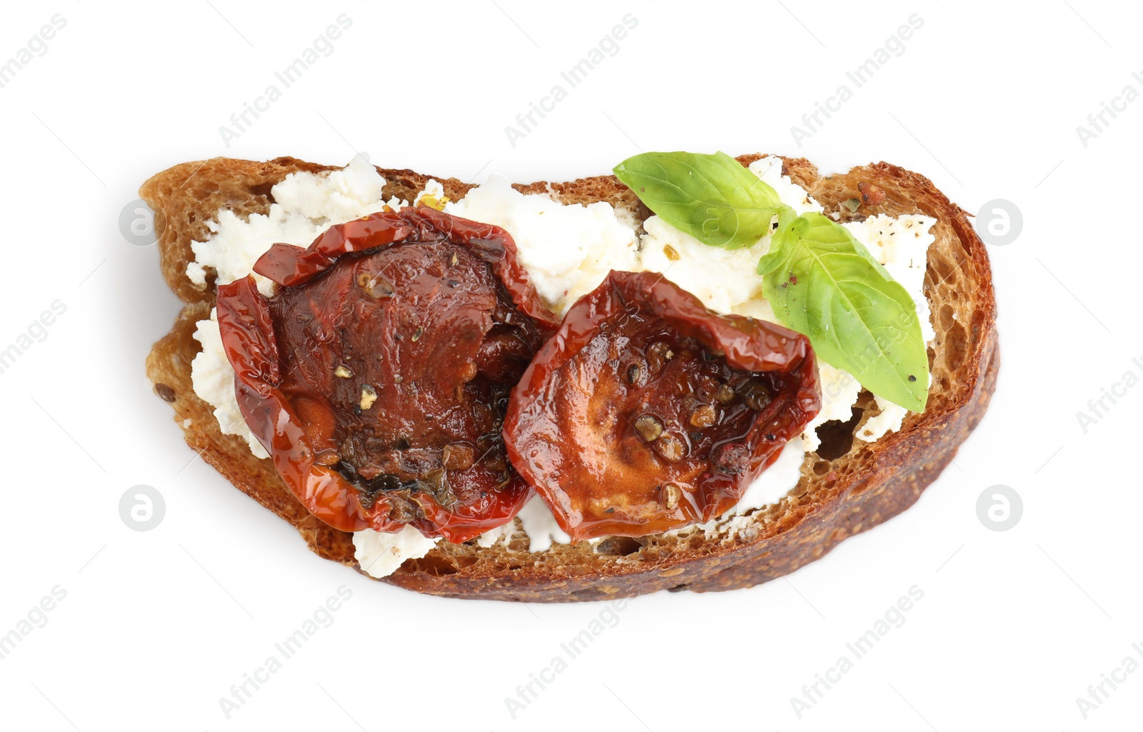 Photo of Delicious ricotta bruschetta with sun dried tomatoes and basil isolated on white, top view