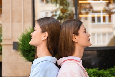 Portrait of two beautiful twin sisters outdoors