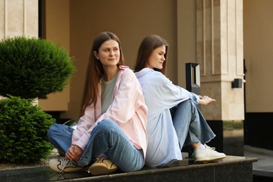 Portrait of two beautiful twin sisters outdoors