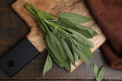 Fresh sage leaves on wooden table, top view