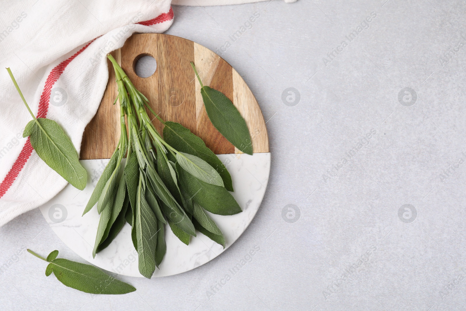 Photo of Fresh sage leaves on light grey table, top view. Space for text