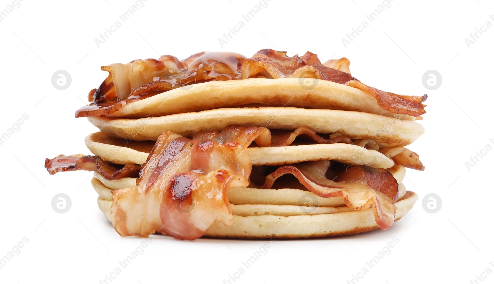 Photo of Pouring maple syrup onto delicious pancakes with fried bacon isolated on white