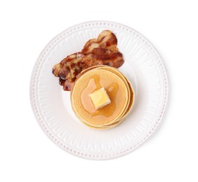 Delicious pancakes with butter and fried bacon isolated on white, top view