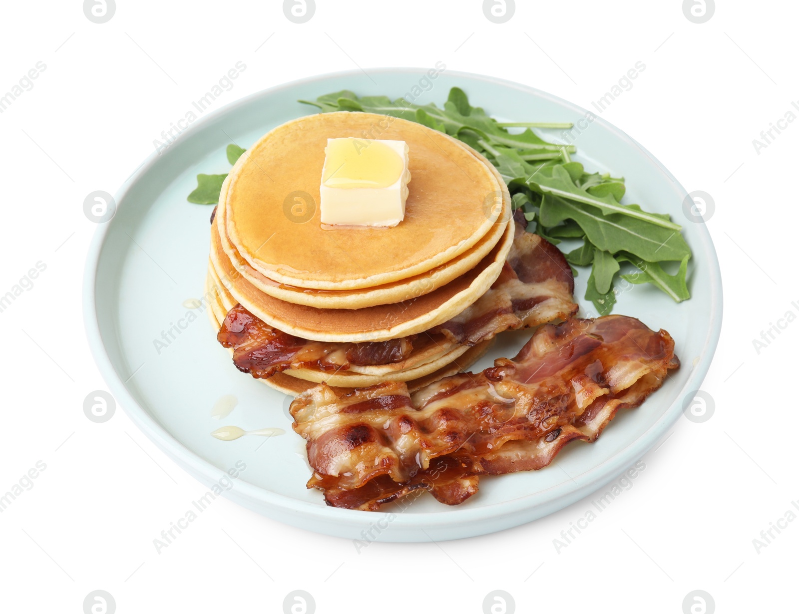 Photo of Tasty pancakes with butter, fried bacon and fresh arugula isolated on white