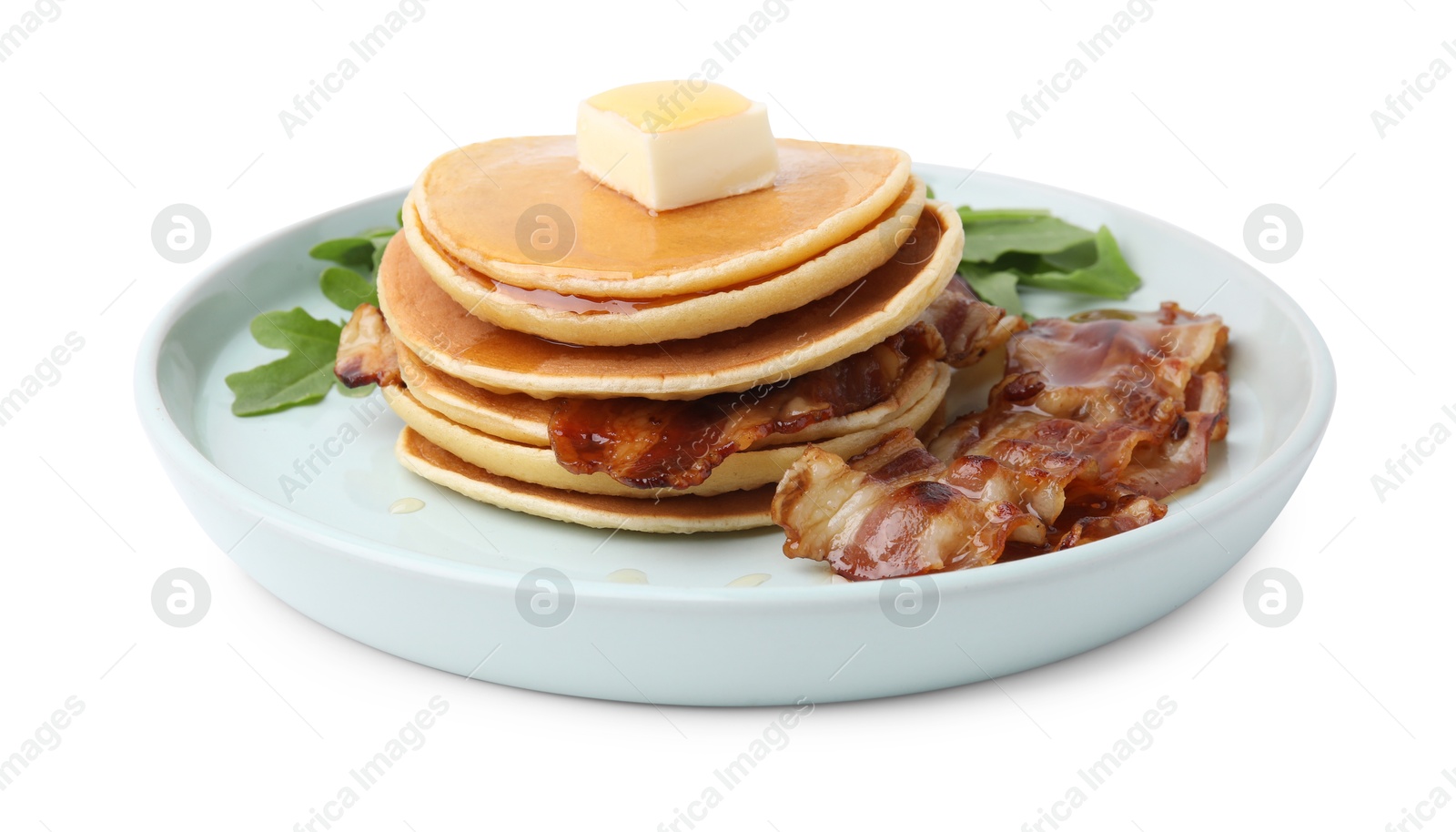 Photo of Tasty pancakes with butter, fried bacon and fresh arugula isolated on white