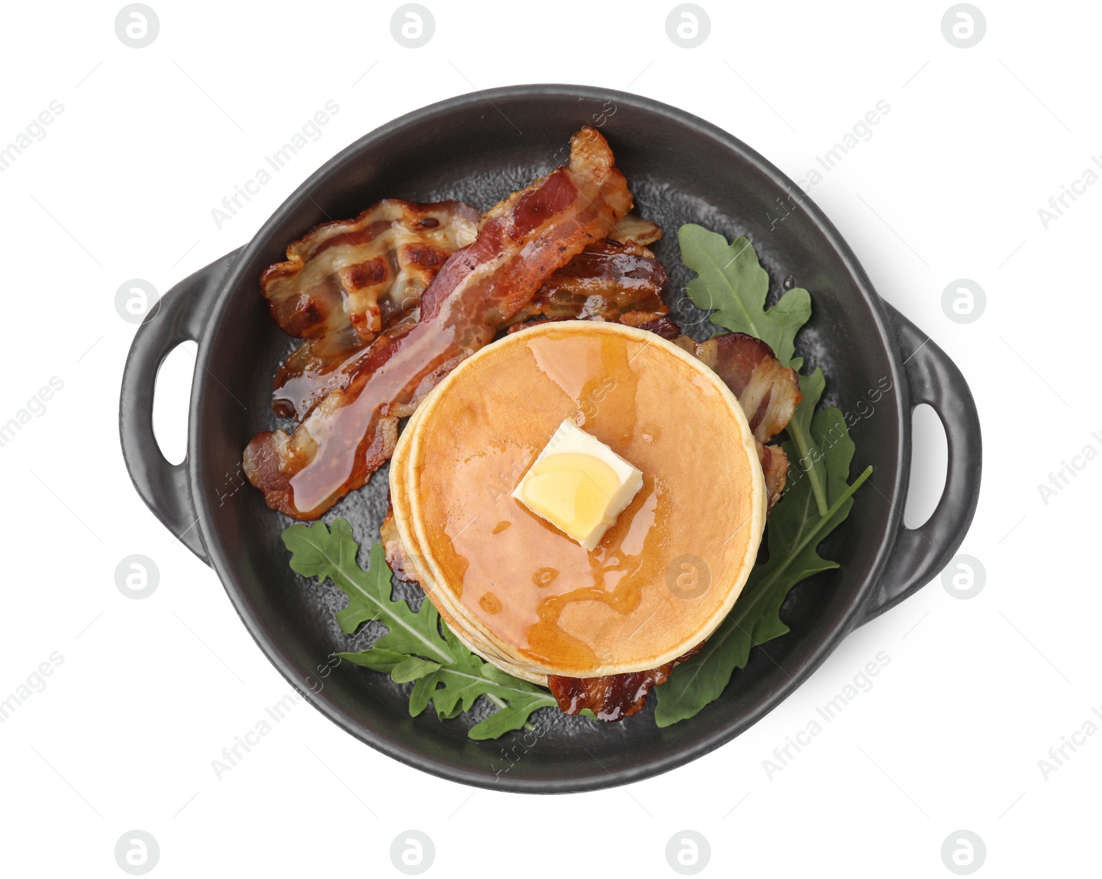 Photo of Tasty pancakes with butter, fried bacon and fresh arugula isolated on white, top view