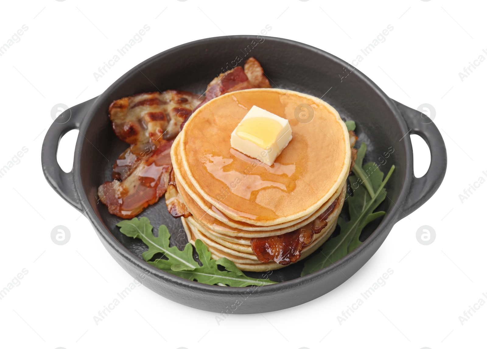 Photo of Tasty pancakes with butter, fried bacon and fresh arugula isolated on white