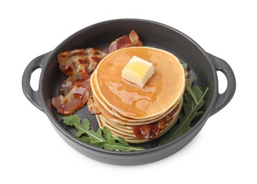 Photo of Tasty pancakes with butter, fried bacon and fresh arugula isolated on white