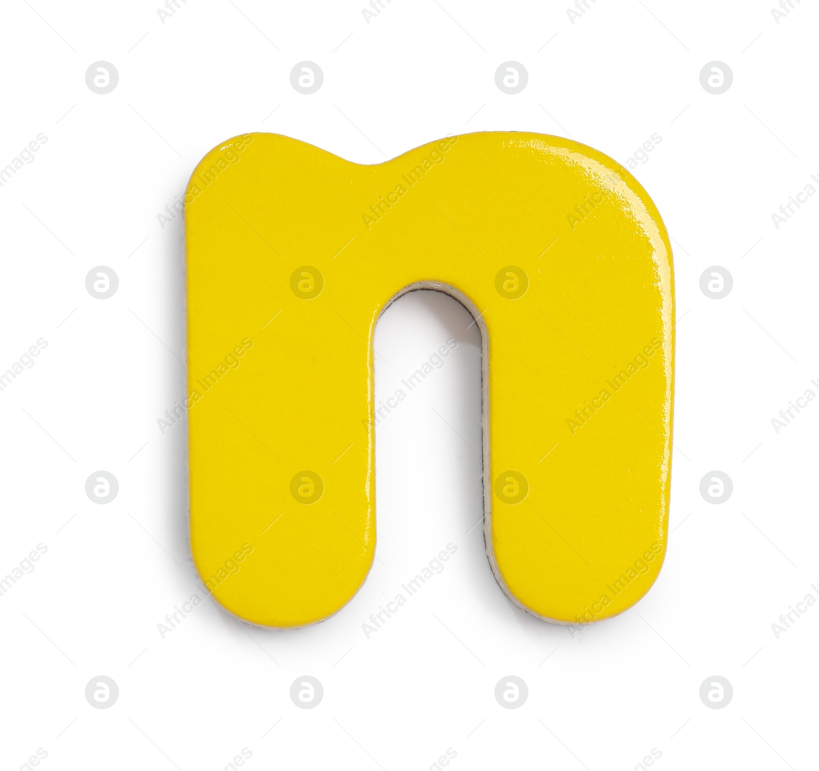 Photo of Yellow magnetic letter N isolated on white, top view. Alphabet