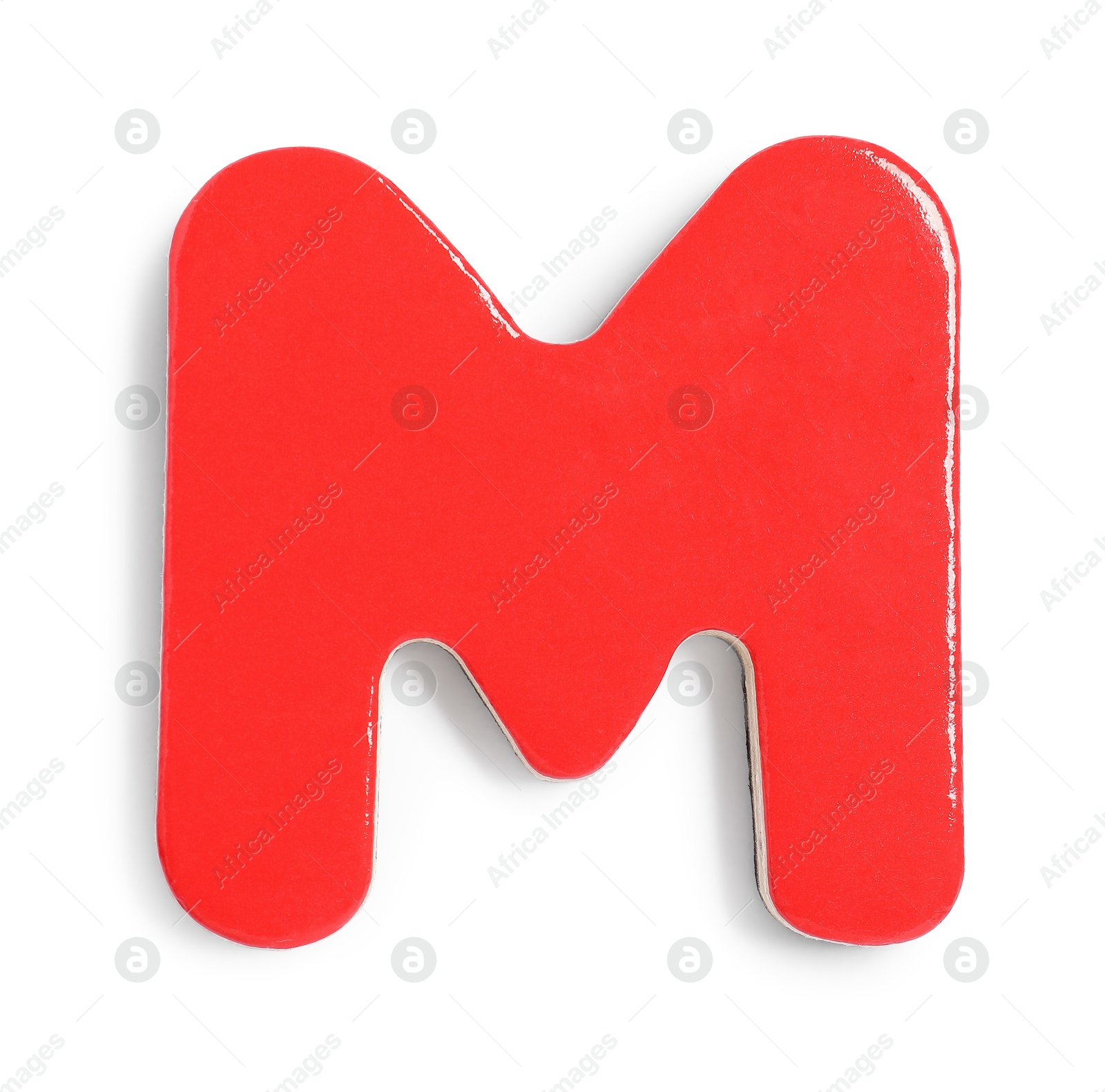 Photo of Red magnetic letter M isolated on white, top view. Alphabet