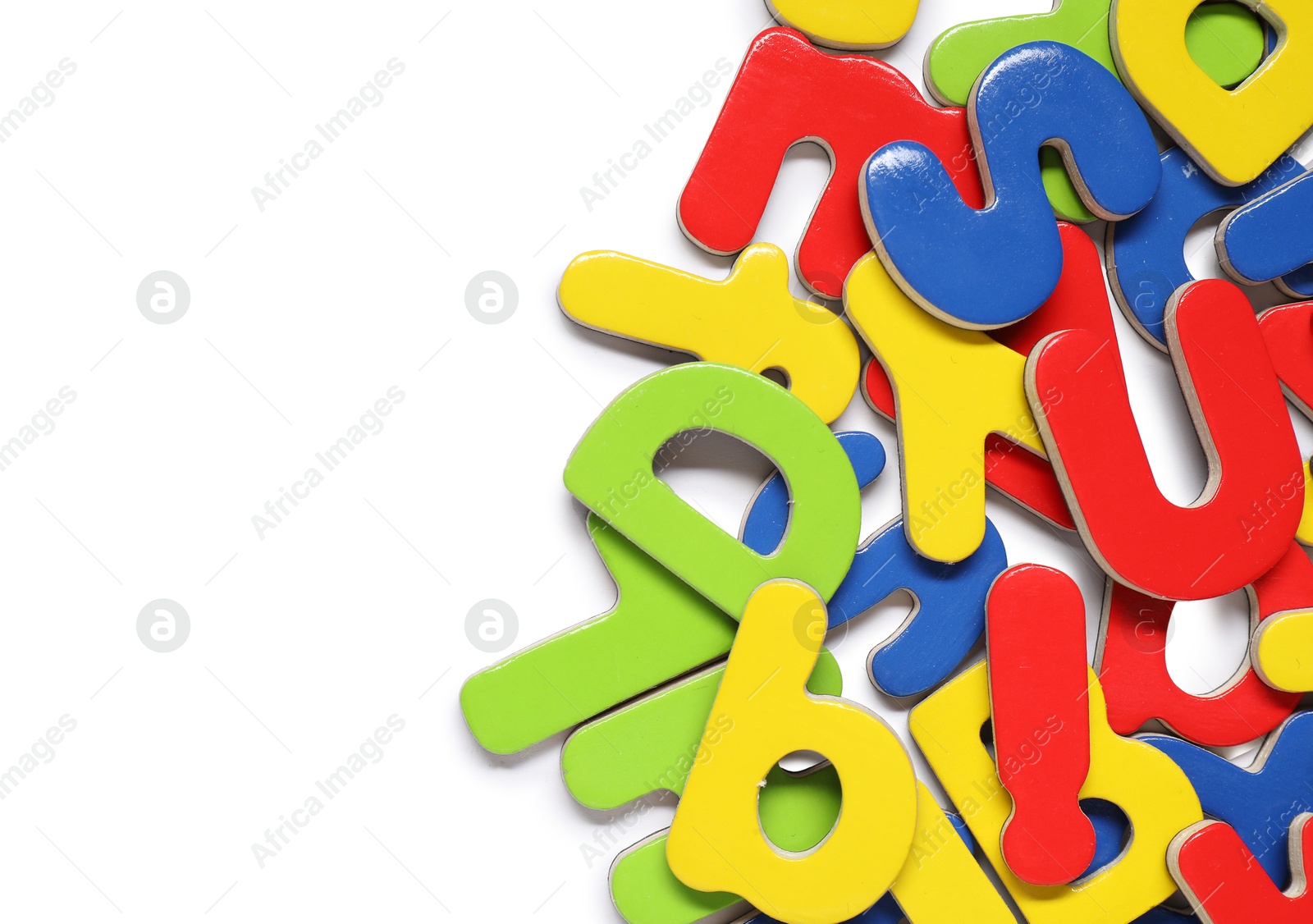 Photo of Alphabet. Many colorful magnetic letters isolated on white, top view