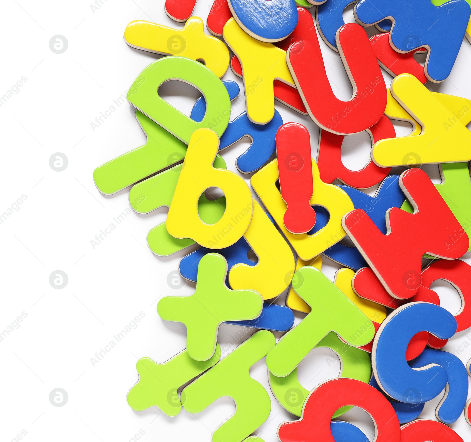 Photo of Alphabet. Many colorful magnetic letters isolated on white, top view