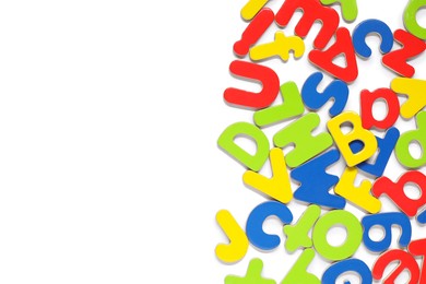 Alphabet. Many colorful magnetic letters isolated on white, top view