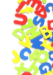 Photo of Alphabet. Many colorful magnetic letters isolated on white, top view