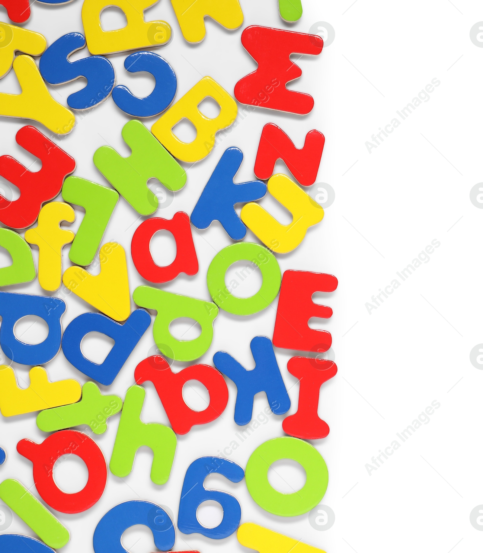 Photo of Alphabet. Many colorful magnetic letters isolated on white, top view