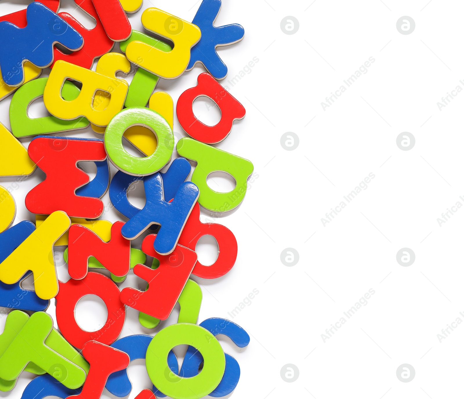 Photo of Alphabet. Many colorful magnetic letters isolated on white, top view