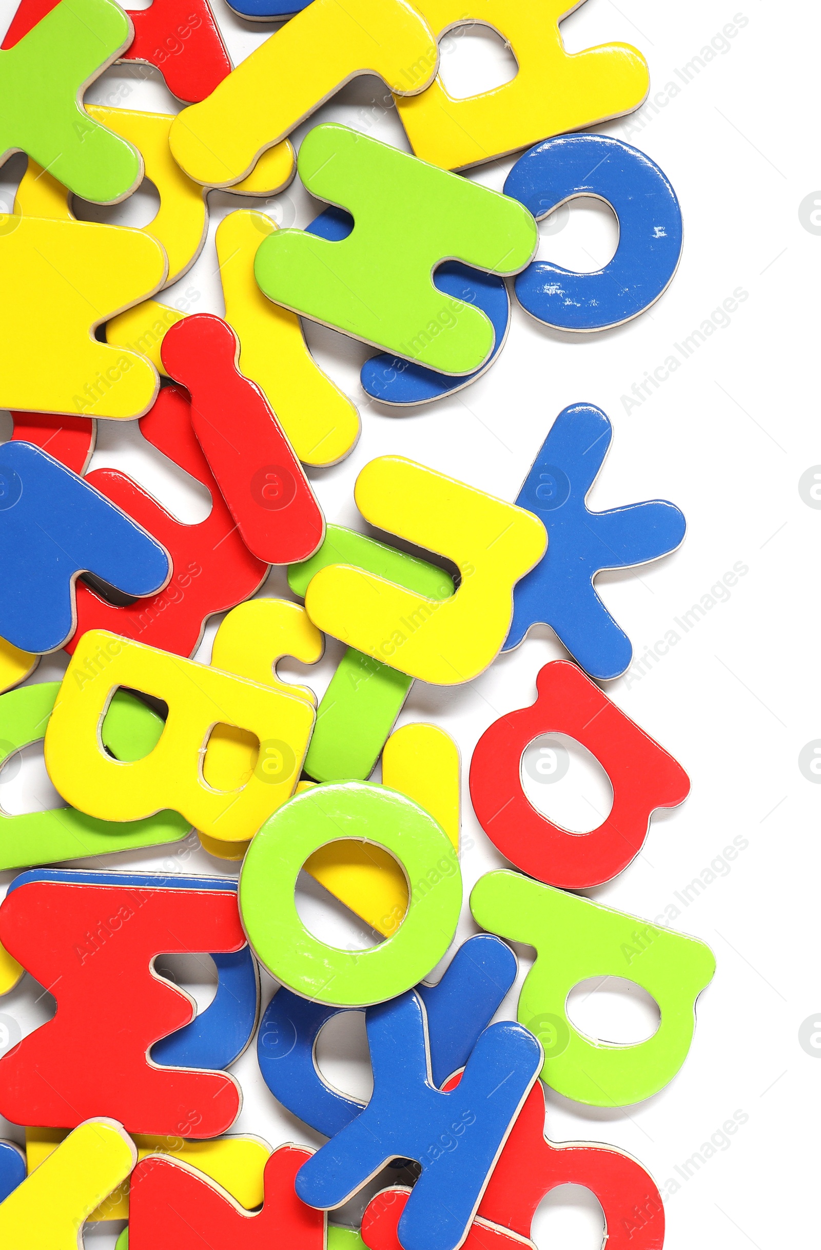 Photo of Alphabet. Many colorful magnetic letters isolated on white, top view